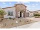 Inviting single-Gathering home showcasing a stone entrance and a spacious two-car garage at 24275 N 173Rd Ave, Surprise, AZ 85387