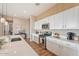 Bright kitchen with white cabinets, quartz counters, and stainless steel appliances at 24275 N 173Rd Ave, Surprise, AZ 85387