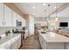 Modern kitchen featuring white cabinets, stainless steel appliances, and a large center island at 24275 N 173Rd Ave, Surprise, AZ 85387