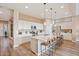 Eat-in kitchen with white cabinetry, stainless steel appliances, and a quartz kitchen island at 24275 N 173Rd Ave, Surprise, AZ 85387