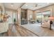 Comfortable living room featuring wood floors, custom cabinets and sliding glass doors to outdoor patio at 24275 N 173Rd Ave, Surprise, AZ 85387