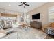 Open-concept living room with cozy furniture, and modern ceiling fan, flowing into a stylish kitchen at 24275 N 173Rd Ave, Surprise, AZ 85387