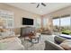 Relaxing living room with large television, ceiling fan and sliding glass doors to the outdoor patio at 24275 N 173Rd Ave, Surprise, AZ 85387