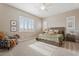 Inviting main bedroom featuring a comfortable bed, soft carpet, and natural light from two windows at 24275 N 173Rd Ave, Surprise, AZ 85387