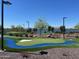 Lakeside putting green with artificial turf, sand traps, and mature trees at 24275 N 173Rd Ave, Surprise, AZ 85387