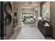 Elegant foyer featuring a modern light fixture and entryway flowing seamlessly into the living room at 24283 S 219Th Way, Queen Creek, AZ 85142