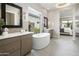 Luxurious main bathroom featuring a soaking tub, dual vanities, and an open design for a relaxing and modern feel at 24283 S 219Th Way, Queen Creek, AZ 85142