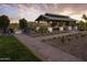 Inviting outdoor pavilion with a fire pit, seating, and lush landscaping, ideal for gatherings at 24283 S 219Th Way, Queen Creek, AZ 85142