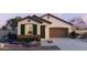 Charming single-story home with a neutral color palette, green shutters, and well-manicured landscaping at 25286 N 156Th Ln, Surprise, AZ 85387