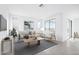 Inviting living room bathed in natural light, complemented by a cozy sofa, textured rug, and stylish decor at 25286 N 156Th Ln, Surprise, AZ 85387