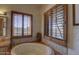 Bright bathroom with a luxurious tub, tiled detailing, and expansive windows providing natural light and views at 3119 Arroyo Hondo --, Carefree, AZ 85377