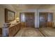 Inviting foyer with a mirrored wall, console table, rustic wood doors, and decorative touches at 3119 Arroyo Hondo --, Carefree, AZ 85377