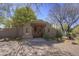 Charming front entrance with an address plaque, custom wood doors, and desert landscaping with mature trees at 3119 Arroyo Hondo --, Carefree, AZ 85377