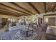 Living room featuring beamed ceilings, a fireplace, and a large rug, creating a cozy and inviting space at 3119 Arroyo Hondo --, Carefree, AZ 85377