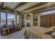 Relaxing main bedroom with exposed beams, seating area, fireplace, and picturesque outdoor views at 3119 Arroyo Hondo --, Carefree, AZ 85377