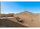 The backyard featuring desert landscaping, block fencing and mountain views at 34210 N Beeblossom Trl, San Tan Valley, AZ 85144