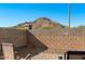 This home's backyard features brick landscaping, desert plants and a mountain view at 34210 N Beeblossom Trl, San Tan Valley, AZ 85144