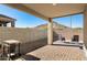 Desert backyard featuring a covered patio, mountain views, desert landscaping and brick pavers at 34210 N Beeblossom Trl, San Tan Valley, AZ 85144