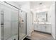 Bright bathroom features a glass enclosed shower and double sink vanity with gray wood-look tile flooring at 34210 N Beeblossom Trl, San Tan Valley, AZ 85144