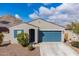 Charming single-story home with blue garage door, shutters, and a low maintenance desert landscape at 34210 N Beeblossom Trl, San Tan Valley, AZ 85144