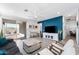 Cozy living area with a blue accent wall, white trim, and a sliding glass door leading to the patio at 34210 N Beeblossom Trl, San Tan Valley, AZ 85144