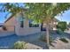 A manicured backyard featuring desert landscaping, a covered patio, and a relaxing hot tub for outdoor enjoyment at 391 N San Ricardo Trl, Casa Grande, AZ 85194