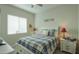 Well-lit bedroom featuring a charming bed with a blue plaid comforter at 391 N San Ricardo Trl, Casa Grande, AZ 85194