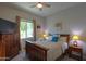 Bright bedroom featuring a wood frame bed with a large window at 391 N San Ricardo Trl, Casa Grande, AZ 85194