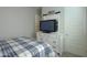 Bedroom featuring a white dresser, TV, and a blue plaid bed at 391 N San Ricardo Trl, Casa Grande, AZ 85194