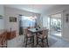 Bright dining area with stylish table, chairs, chandelier, and access to the outdoor patio at 391 N San Ricardo Trl, Casa Grande, AZ 85194