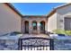 Stunning front entrance with stone arches and a wrought iron gate, offering curb appeal at 391 N San Ricardo Trl, Casa Grande, AZ 85194