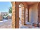 Covered front porch with stone columns and arches, leading to an elegant entryway at 391 N San Ricardo Trl, Casa Grande, AZ 85194