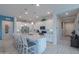 Well-lit kitchen featuring a large island with seating, stainless steel appliances, and white cabinetry at 391 N San Ricardo Trl, Casa Grande, AZ 85194