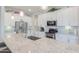 Close-up of kitchen island featuring granite countertops, stainless steel sink and appliances, and white cabinetry at 391 N San Ricardo Trl, Casa Grande, AZ 85194