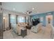 Spacious living room showcasing a ceiling fan, plush seating, and large windows for lots of natural light at 391 N San Ricardo Trl, Casa Grande, AZ 85194