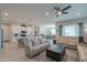 Open-concept living space with kitchen island and living room combo including tile floors and neutral decor at 391 N San Ricardo Trl, Casa Grande, AZ 85194