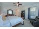 Comfortable main bedroom with ceiling fan, carpeting, and a decorative mirror over a dresser at 391 N San Ricardo Trl, Casa Grande, AZ 85194