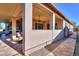 Wonderful covered patio with a hot tub, outdoor seating, and a view to an adjacent gravel area at 391 N San Ricardo Trl, Casa Grande, AZ 85194