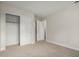 Well-lit bedroom features a closet, neutral carpet, and a door leading to another room at 4053 W Quail Ave, Glendale, AZ 85308