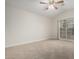 Large bedroom with neutral carpet, ceiling fan, and sliding glass door to patio at 4053 W Quail Ave, Glendale, AZ 85308