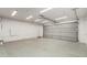 Spacious garage with concrete flooring, ample lighting, and a large door at 4053 W Quail Ave, Glendale, AZ 85308