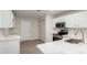 Modern kitchen featuring white cabinets, stainless steel appliances, and quartz countertops at 4053 W Quail Ave, Glendale, AZ 85308