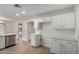 Well-lit kitchen with white cabinets, stainless steel dishwasher, and light countertops at 4053 W Quail Ave, Glendale, AZ 85308