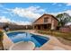 Backyard featuring a beautiful pool with a slide, a patio, and a two-story home at 4053 W Quail Ave, Glendale, AZ 85308