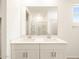 Bright bathroom featuring double sinks with modern fixtures and a large mirror above at 41740 W Sonoran Trl, Maricopa, AZ 85138