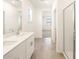 Bathroom featuring a double vanity, tiled floors, and glass-enclosed shower at 41740 W Sonoran Trl, Maricopa, AZ 85138