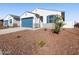 Charming single-story home showcasing a well-manicured front yard and a two-car garage at 41740 W Sonoran Trl, Maricopa, AZ 85138