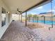 Backyard featuring a covered patio, beautiful stone, and a fenced-in pool, perfect for outdoor enjoyment at 4360 E Sierrita Rd, San Tan Valley, AZ 85143