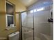 Light-filled bathroom with white tile in glass enclosed shower and frosted window at 650 N Hawes Rd # 4326, Mesa, AZ 85207