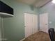 Bedroom with closet and light teal walls, door and carpeted floor at 650 N Hawes Rd # 4326, Mesa, AZ 85207